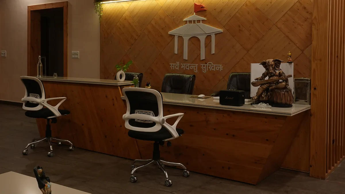 The wooden reception wall of Rishikesh Yogpeeth with the school's temple emblem