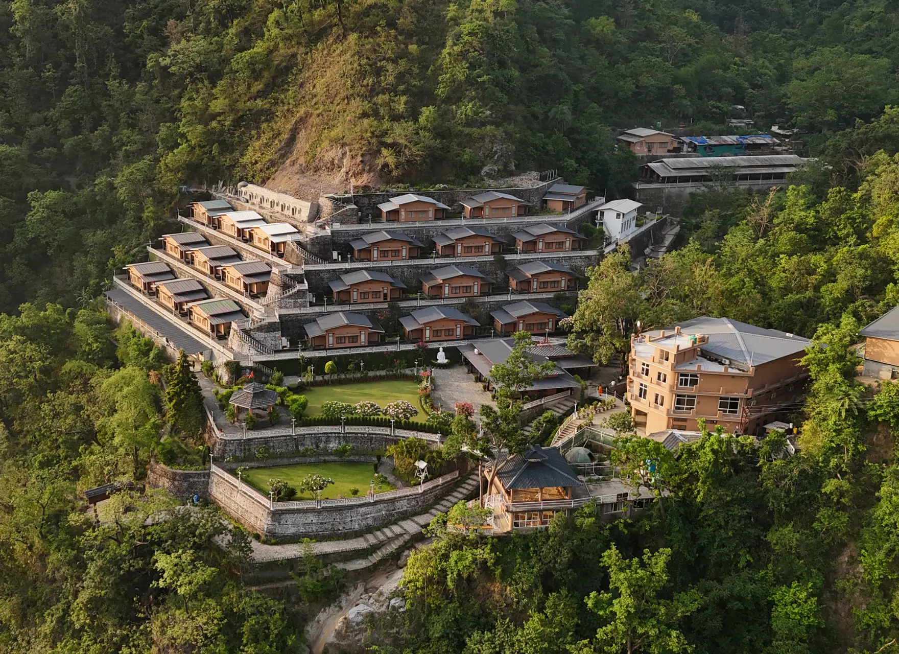 Aerial view of Abhayaranya Ashram cottages in Himalayan forest