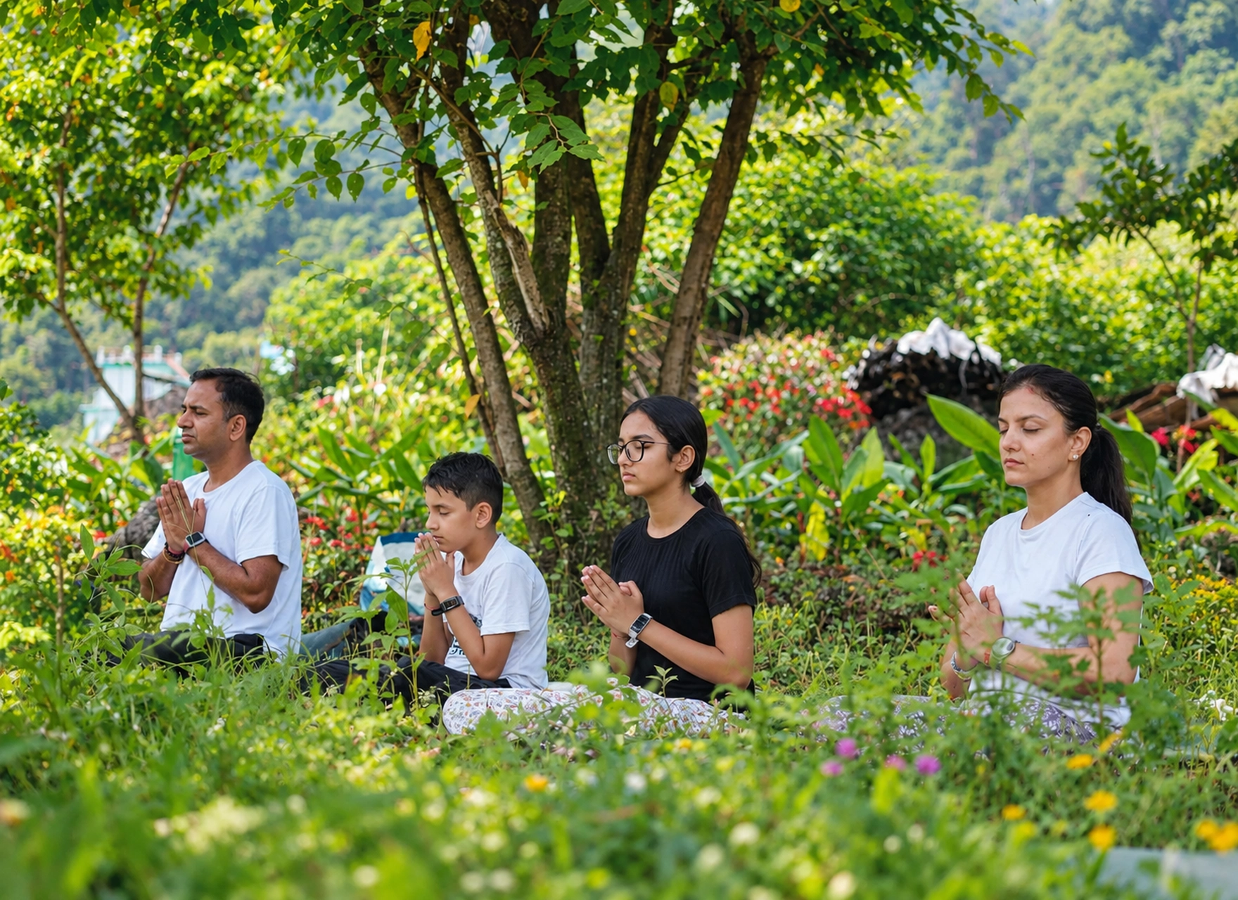 Woman in white practising a yoga pose among bamboo at Abhayaranya Yoga Ashram