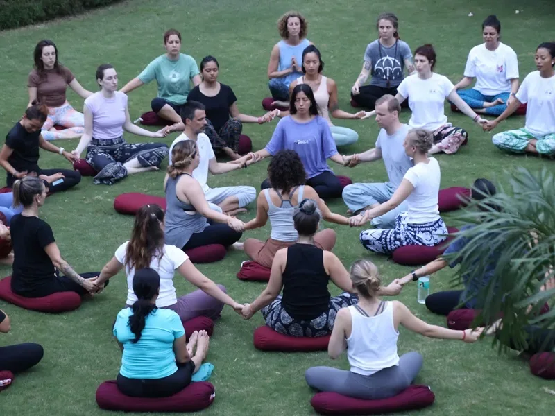 Students seated in a meditation circle on the ashram lawn